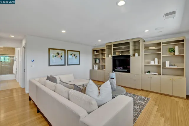 a view of a dining room with furniture a chandelier and wooden floor