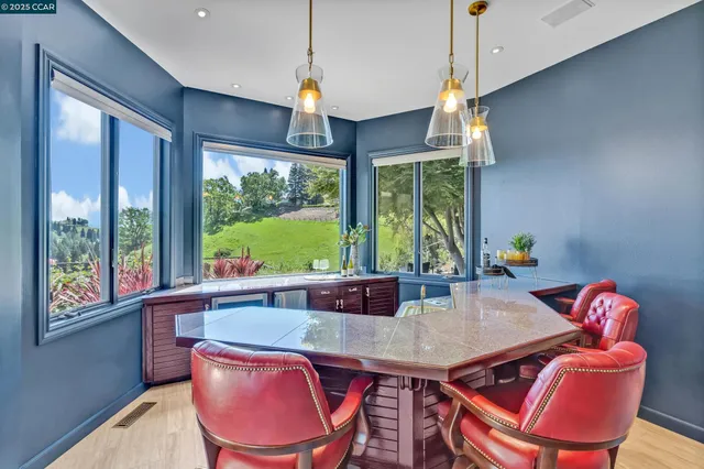 a bathroom with a granite countertop sink a mirror and shower