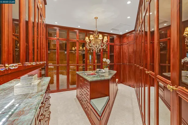 a spacious bedroom with a bed and a chandelier