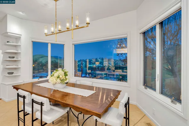 a view of a dining room with furniture large windows and wooden floor