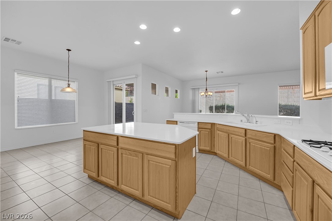 2184 Waterton Rivers Drive Henderson, NV 89044 - Photo 11 of 53 Island Kitchen boasts Corian Countertops, Walk-In Pantry, Recessed Lighting, Breakfast Bar, Large Nook, Tile Flooring, Refrigerator, Gas Cooktop, Built-In Oven, Microwave and Dishwasher