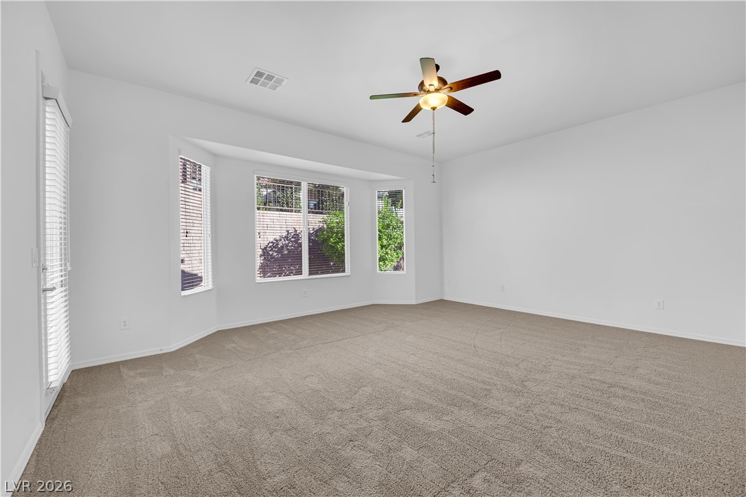 2184 Waterton Rivers Drive Henderson, NV 89044 - Photo 17 of 53 Primary Suite features Ceiling Fan, Bay Window, Door to Back Patio, Walk-In Closet, and Bathroom with Dual Sinks, Garden Tub, and Separate Shower