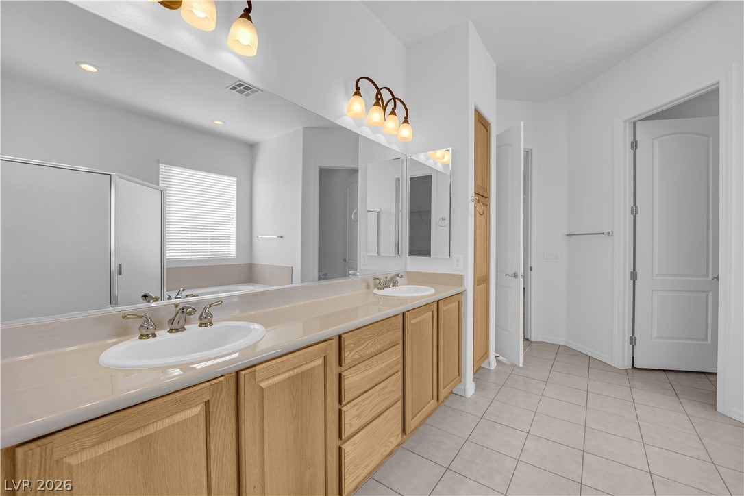 2184 Waterton Rivers Drive Henderson, NV 89044 - Photo 23 of 53 Primary Bathroom with Dual Sinks, Garden Tub, and Separate Shower