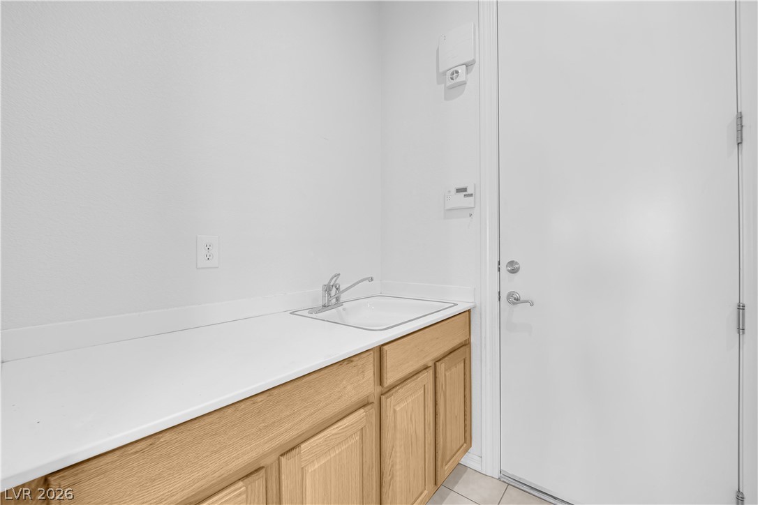 2184 Waterton Rivers Drive Henderson, NV 89044 - Photo 31 of 53 Laundry Room with Cabinets, Utility Sink, and Washer & Dryer