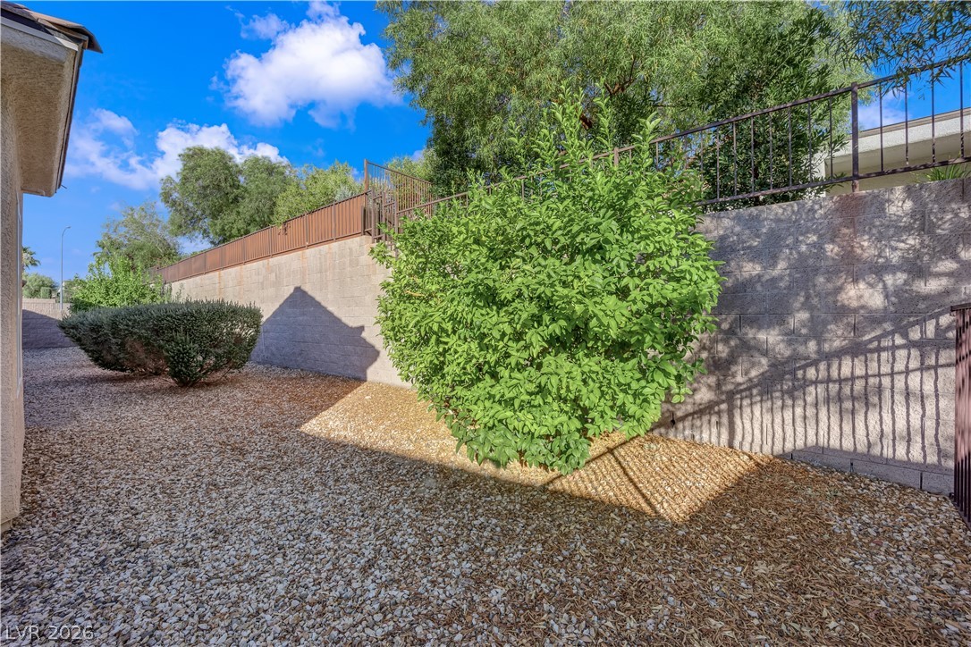 2184 Waterton Rivers Drive Henderson, NV 89044 - Photo 35 of 53 Mature Low Maintenance Landscaping with Rock, Shrubs, and Automatic Irrigation System on Timer