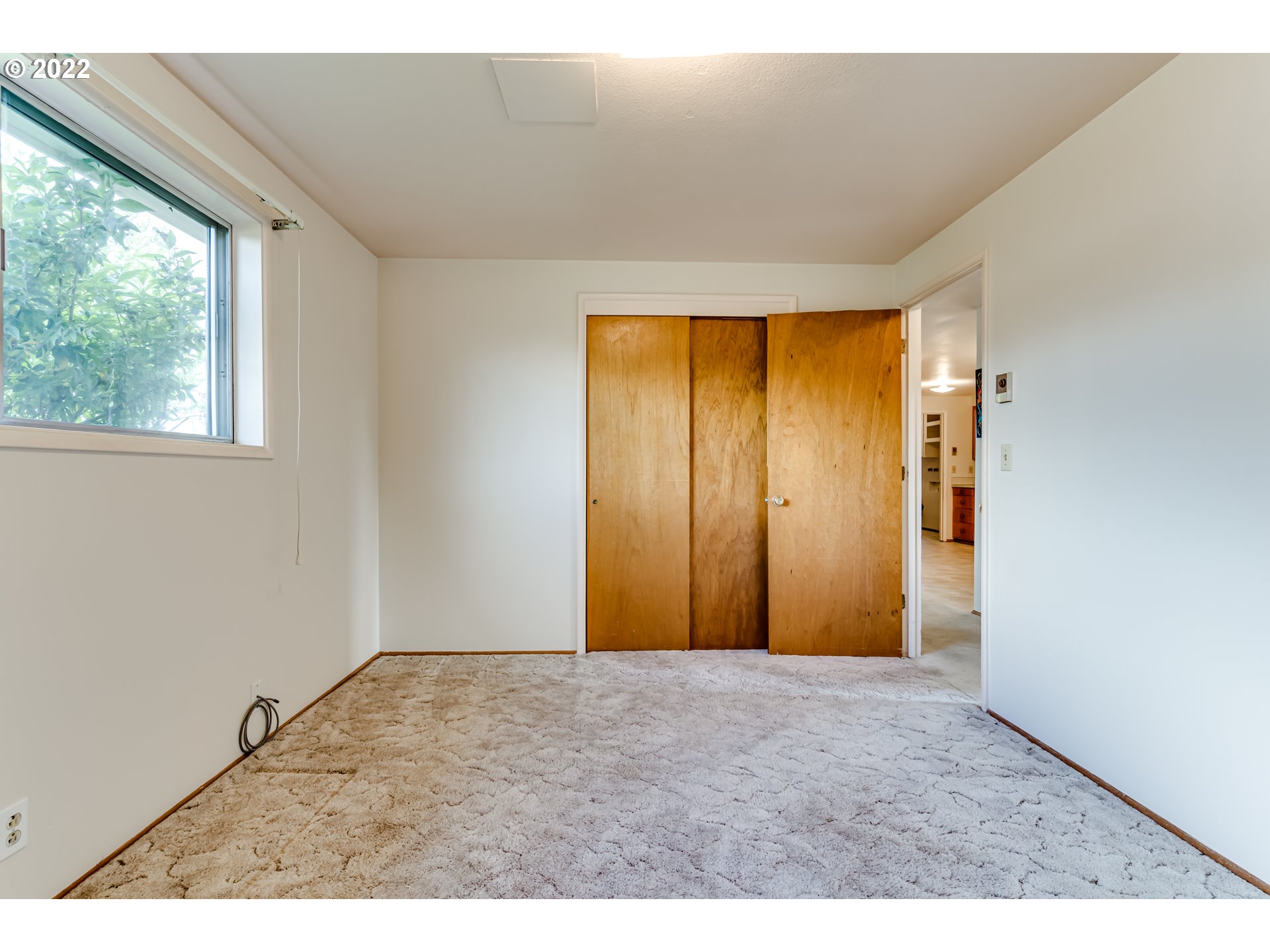 305 37th Street Springfield, OR 97478 - Photo 11 of 18 a view of an empty room with wooden floor and a window