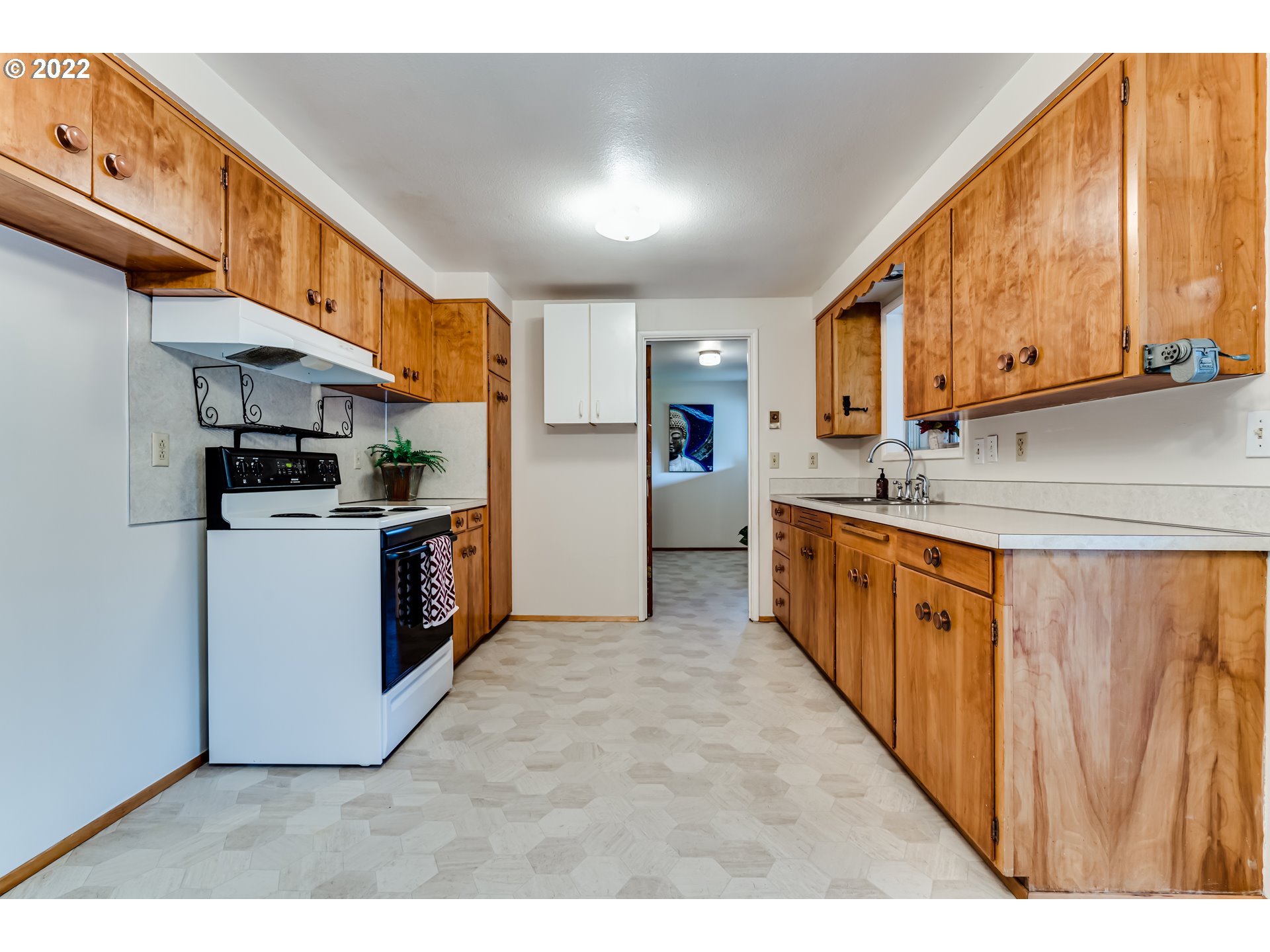 305 37th Street Springfield, OR 97478 - Photo 6 of 18 a kitchen with stainless steel appliances kitchen island wooden cabinets and entryway