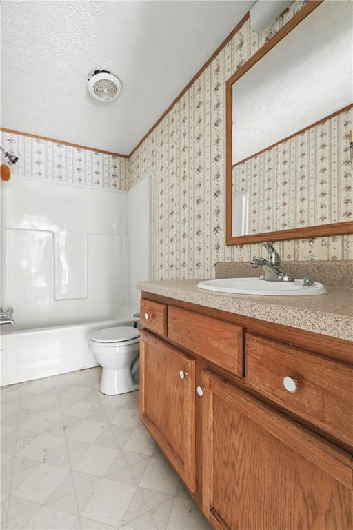 249 John Golden Road Temple, GA 30179 - Photo 38 of 45 a bathroom with a granite countertop sink a toilet and a large mirror