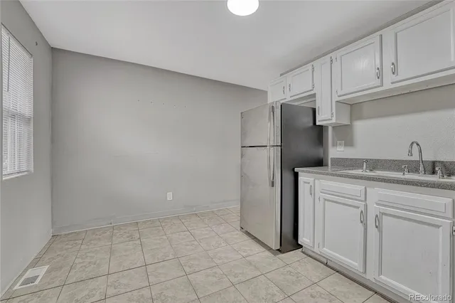 a kitchen with white cabinets and white appliances