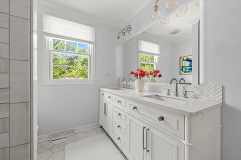 a bathroom with a double vanity sink and a mirror