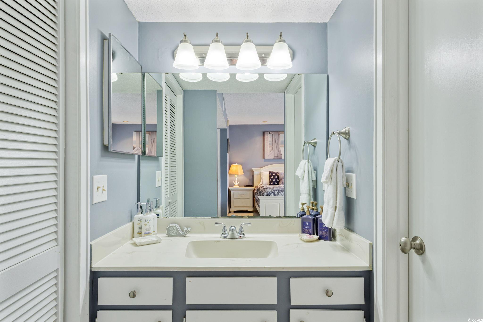351 Lake Arrowhead Road, Unit 2206 Myrtle Beach, SC 29572 - Photo 16 of 40 Bathroom featuring a closet, ensuite bathroom, and vanity