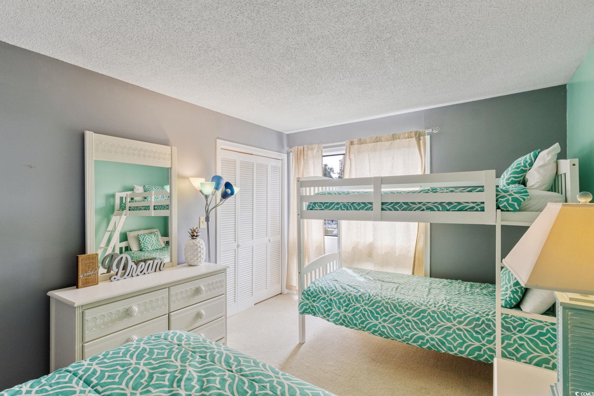 351 Lake Arrowhead Road, Unit 2206 Myrtle Beach, SC 29572 - Photo 19 of 40 Bedroom featuring carpet flooring, a textured ceiling, and a closet