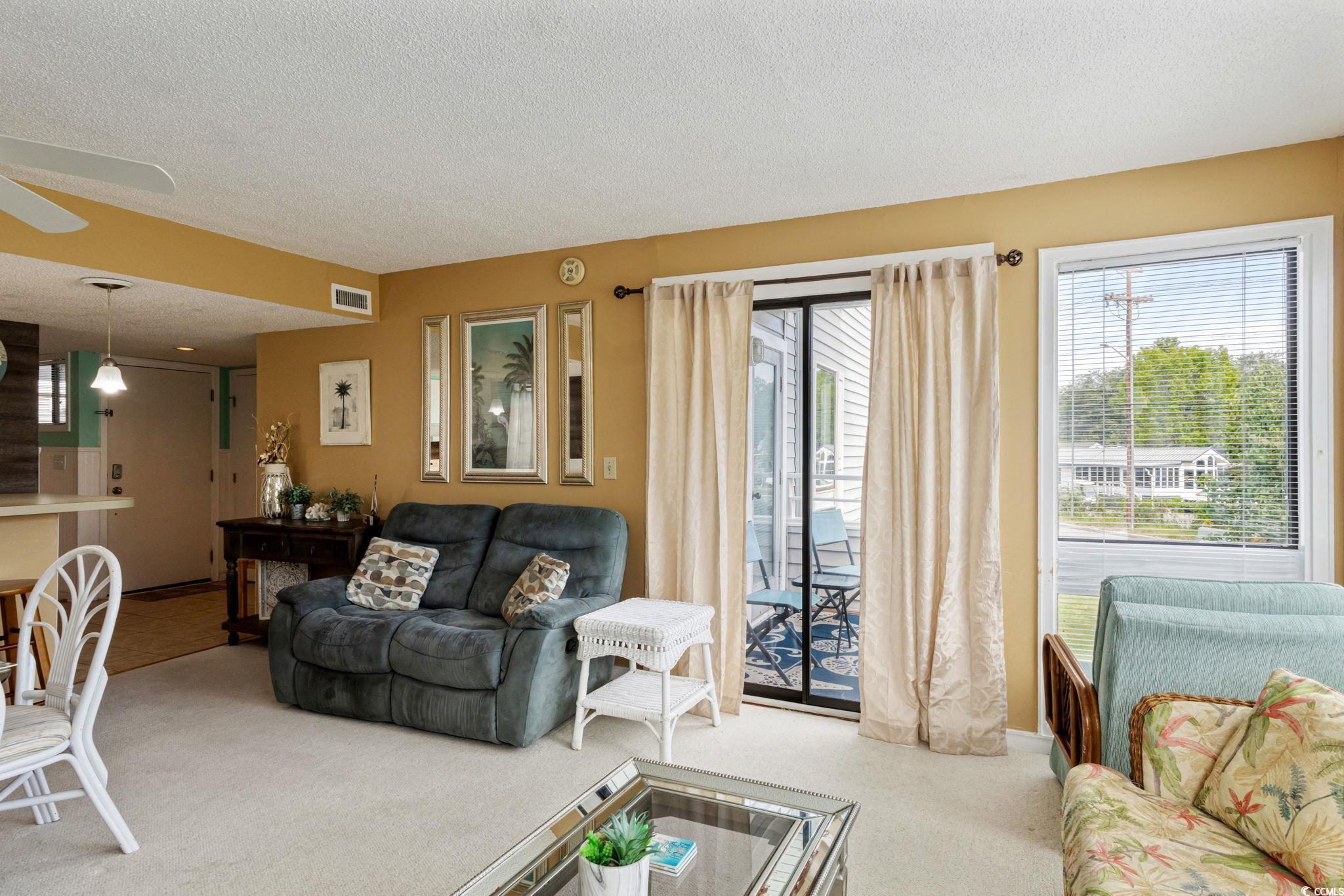 351 Lake Arrowhead Road, Unit 2206 Myrtle Beach, SC 29572 - Photo 6 of 40 Living room featuring a textured ceiling and carpet floors