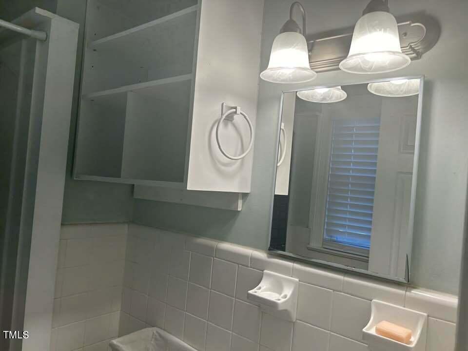 1608 Sulgrave Road Greenville, NC 27858 - Photo 23 of 31 a bathroom with a sink a light fixture and a window
