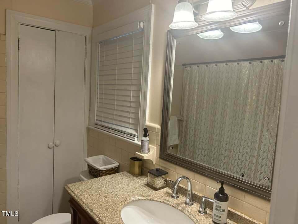 1608 Sulgrave Road Greenville, NC 27858 - Photo 28 of 31 a bathroom with a granite countertop sink and a mirror