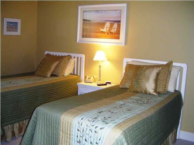2913 Pine Valley Road Miramar Beach, FL 32550 - Photo 19 of 24 a bedroom with a bed and wooden floor