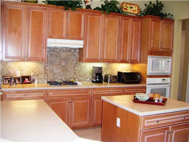 2913 Pine Valley Road Miramar Beach, FL 32550 - Photo 10 of 24 a kitchen with stainless steel appliances kitchen island granite countertop a refrigerator and a stove top oven