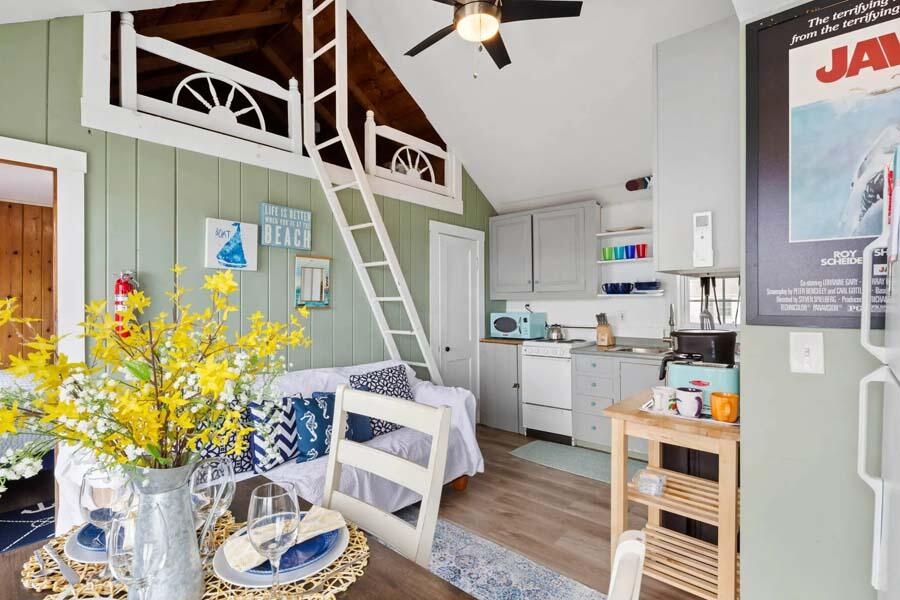 334 Shore Road, Unit 12 Truro, MA 02666 - Photo 12 of 19 a room with furniture a rug and white walls