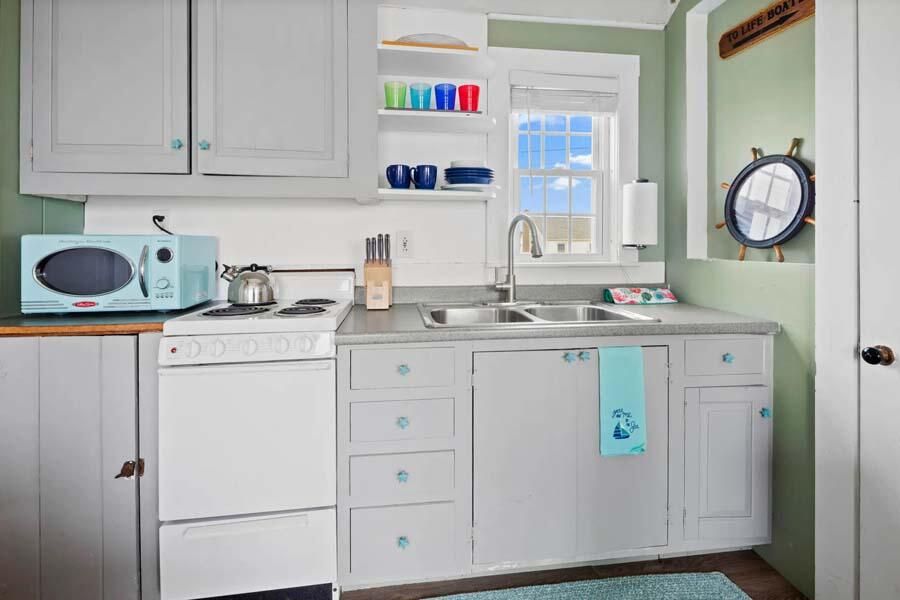 334 Shore Road, Unit 12 Truro, MA 02666 - Photo 14 of 19 a utility room with cabinets washer and dryer