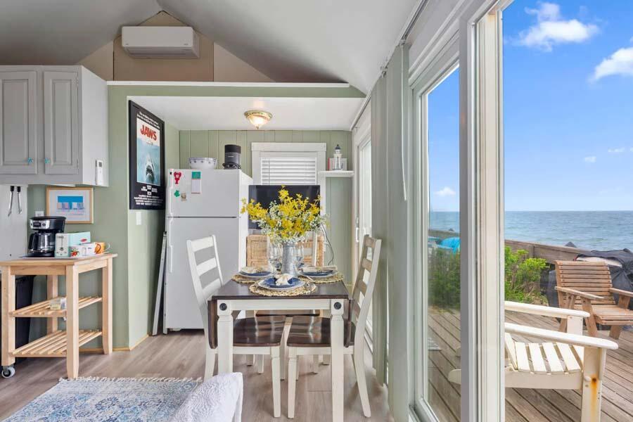 334 Shore Road, Unit 12 Truro, MA 02666 - Photo 15 of 19 a dining room with furniture a rug and wooden floor