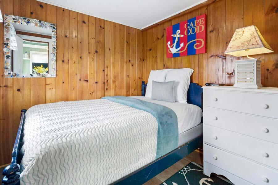 334 Shore Road, Unit 12 Truro, MA 02666 - Photo 16 of 19 a bedroom with a bed and a dresser