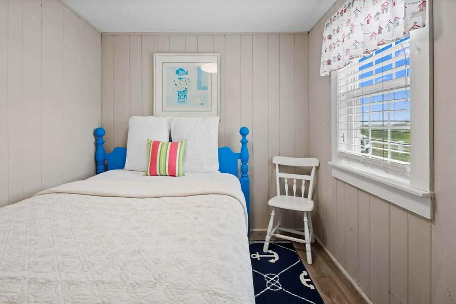 334 Shore Road, Unit 12 Truro, MA 02666 - Photo 17 of 19 a bedroom with a bed and a window