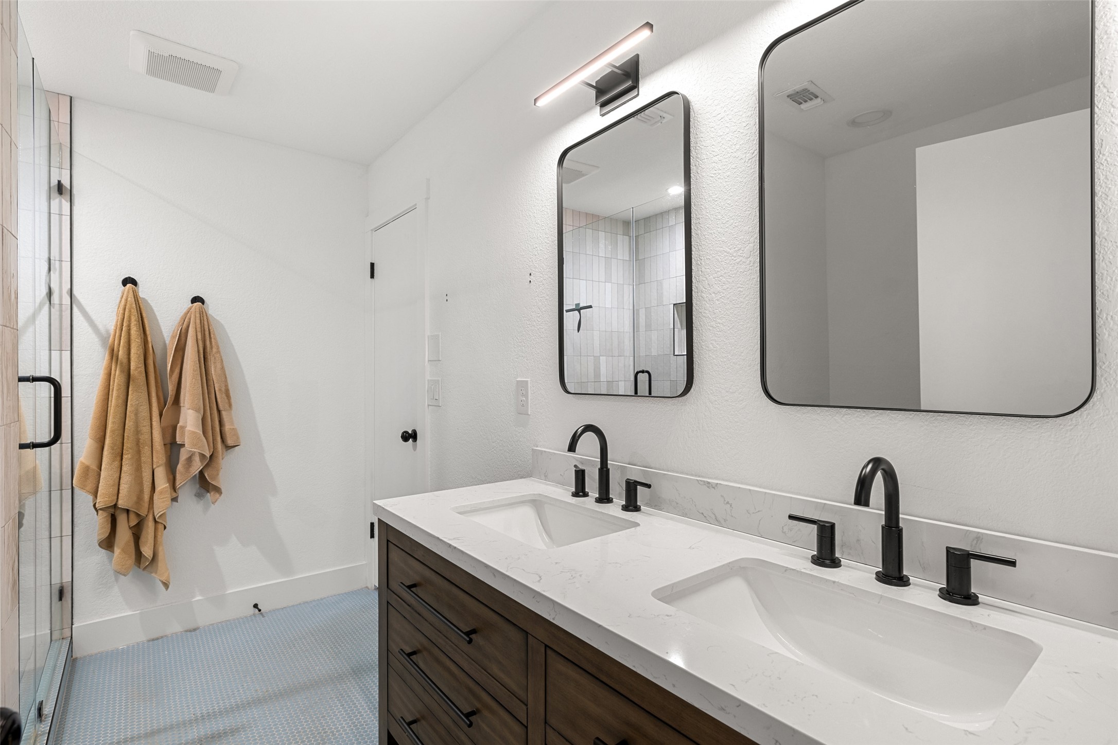 2001 Parker Lane, Unit 101 Austin, TX 78741 - Photo 18 of 33 a bathroom with a double vanity sink and a mirror