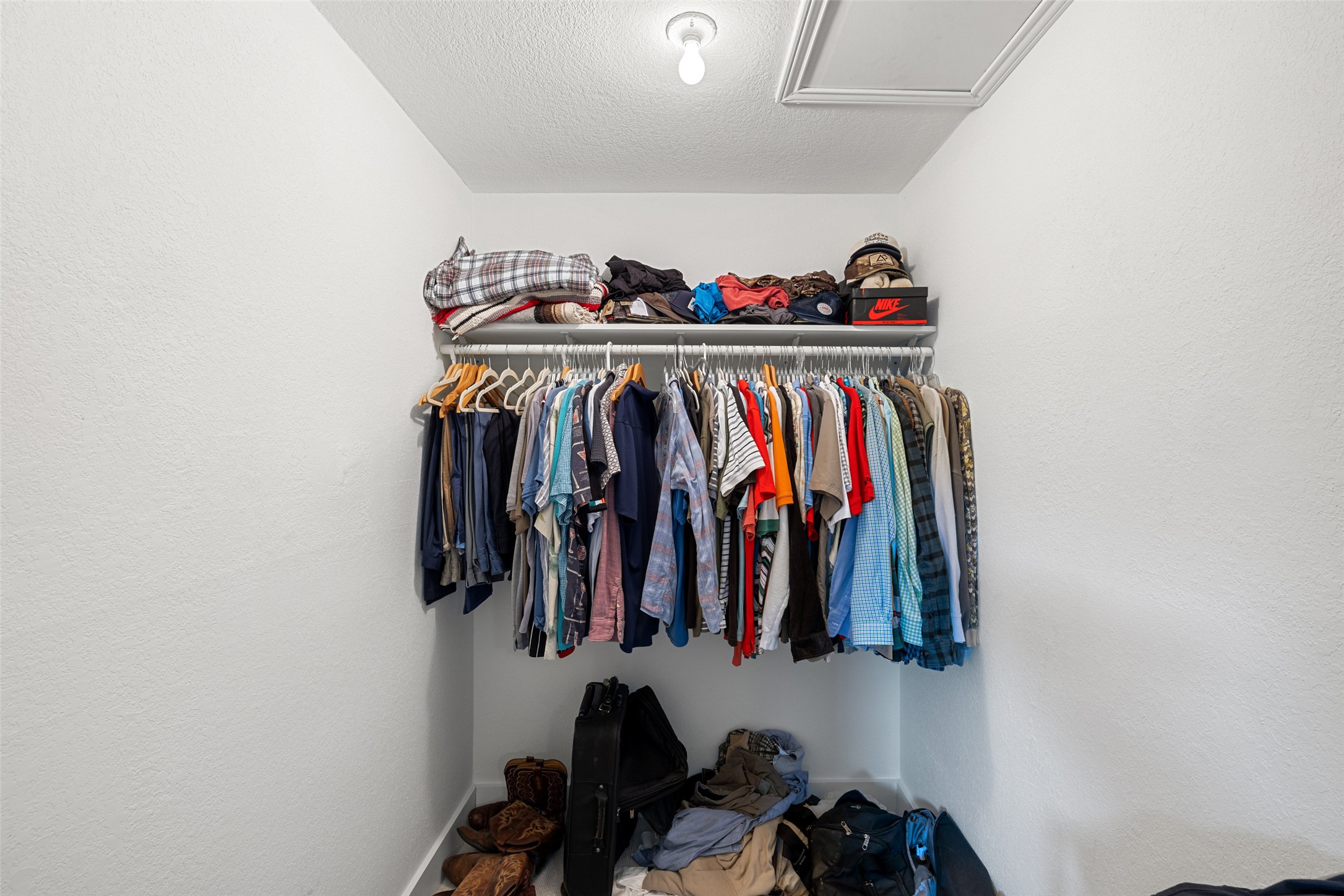 2001 Parker Lane, Unit 101 Austin, TX 78741 - Photo 21 of 33 a view of walk in closet with clothes and shoes