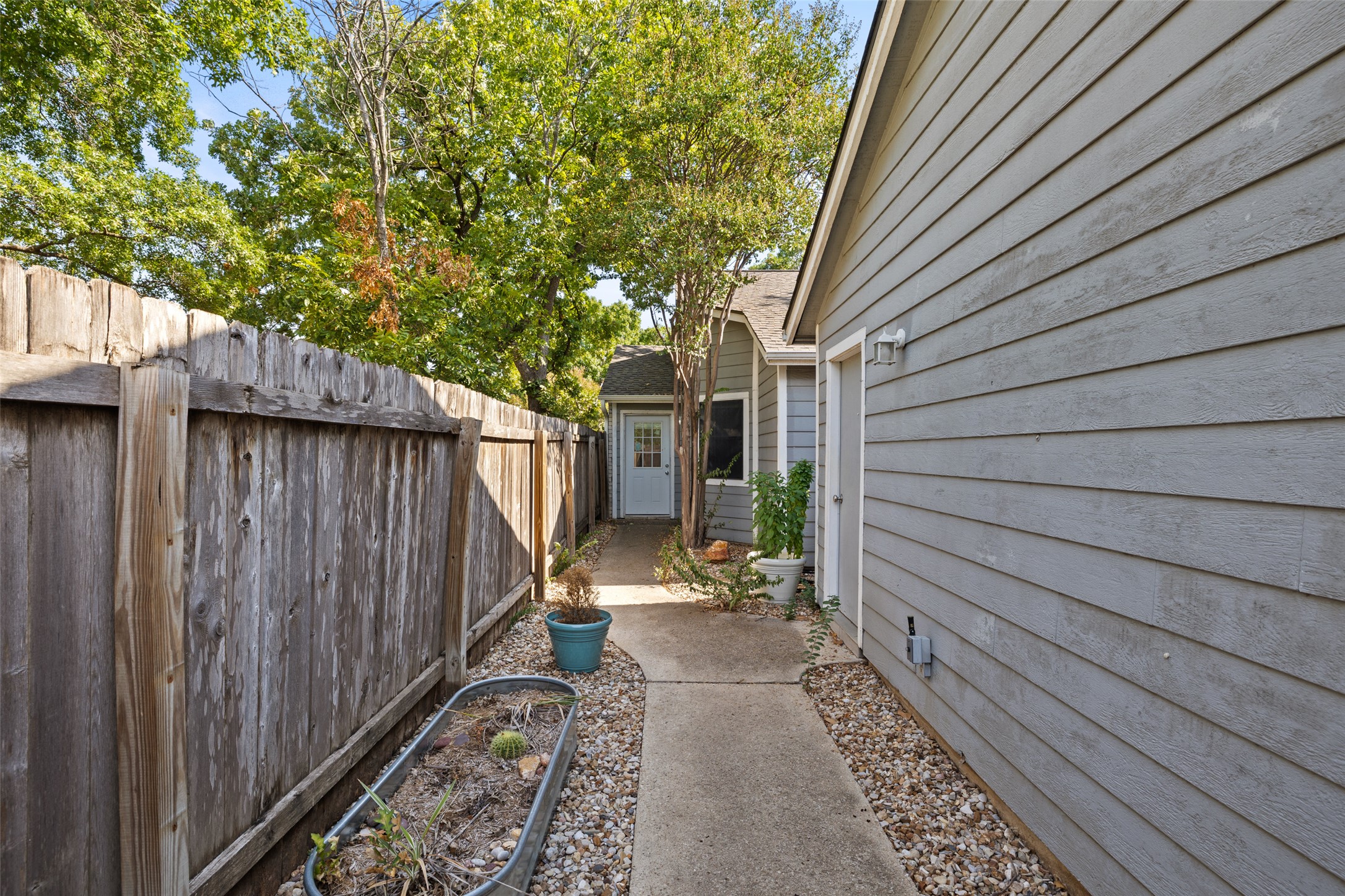 2001 Parker Lane, Unit 101 Austin, TX 78741 - Photo 27 of 33 a view of a pathway of a house with wooden fence