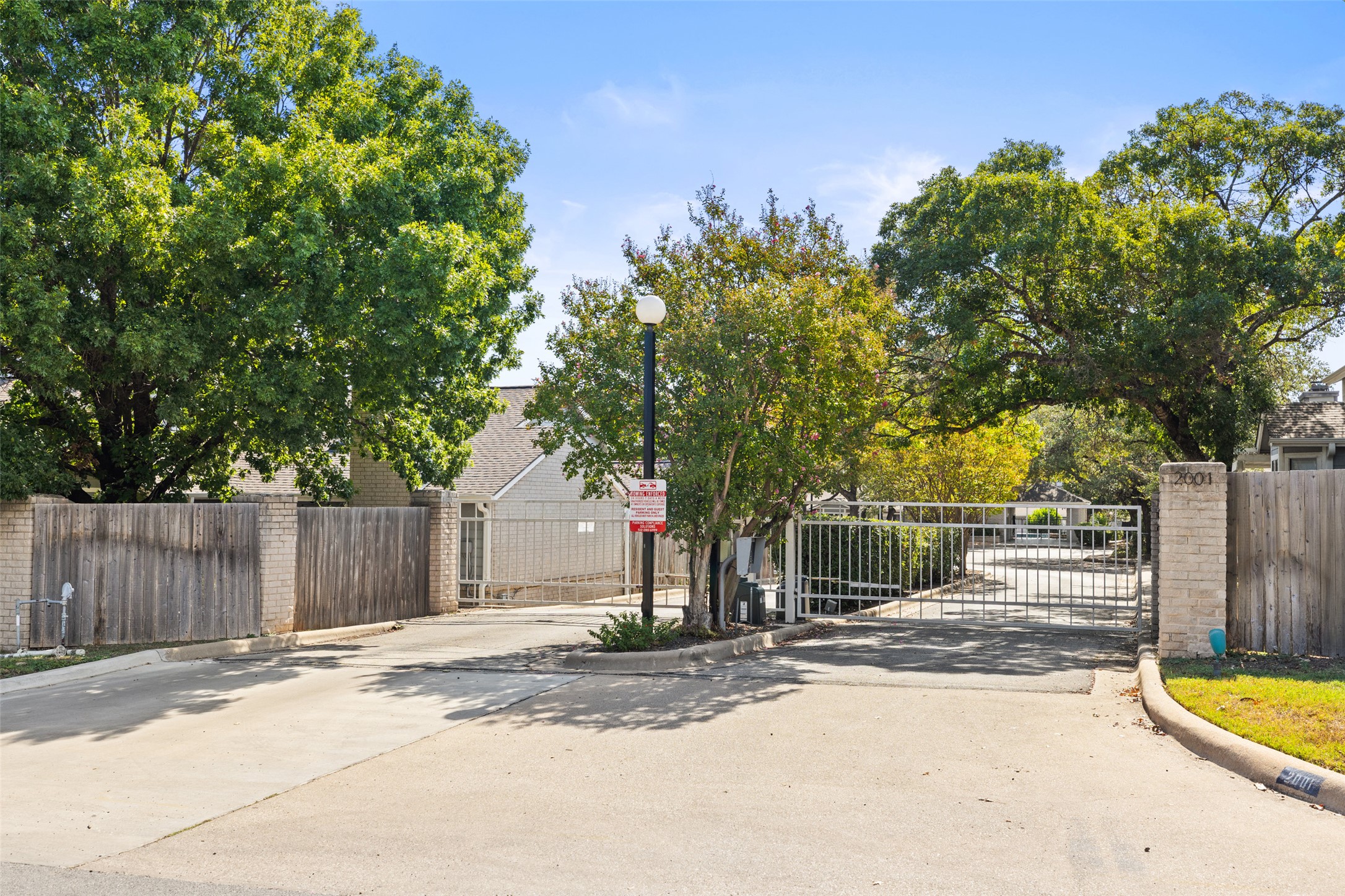 2001 Parker Lane, Unit 101 Austin, TX 78741 - Photo 30 of 33 a view of a house with large tree and wooden fence