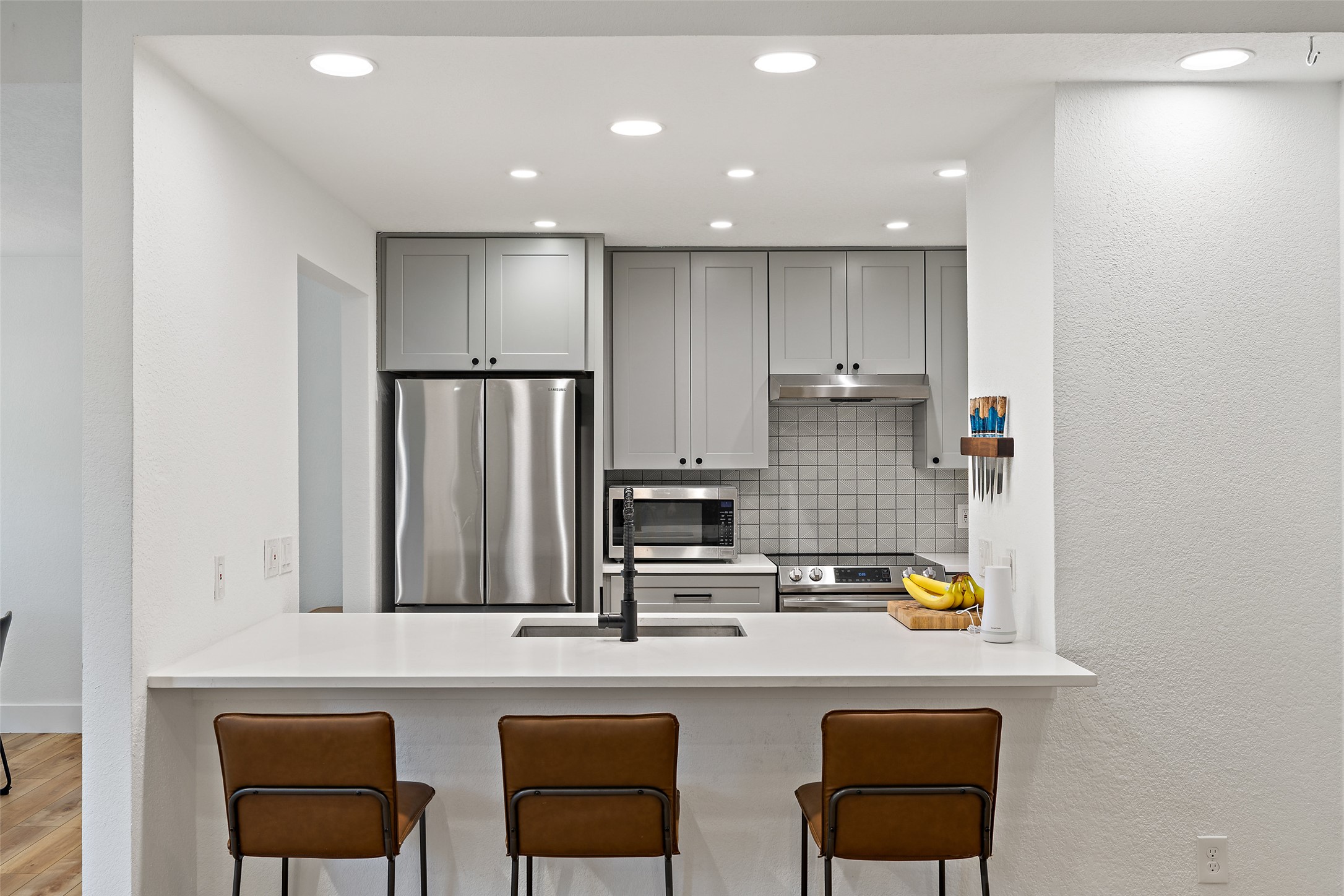 2001 Parker Lane, Unit 101 Austin, TX 78741 - Photo 6 of 33 a kitchen with stainless steel appliances granite countertop a stove a sink and a refrigerator