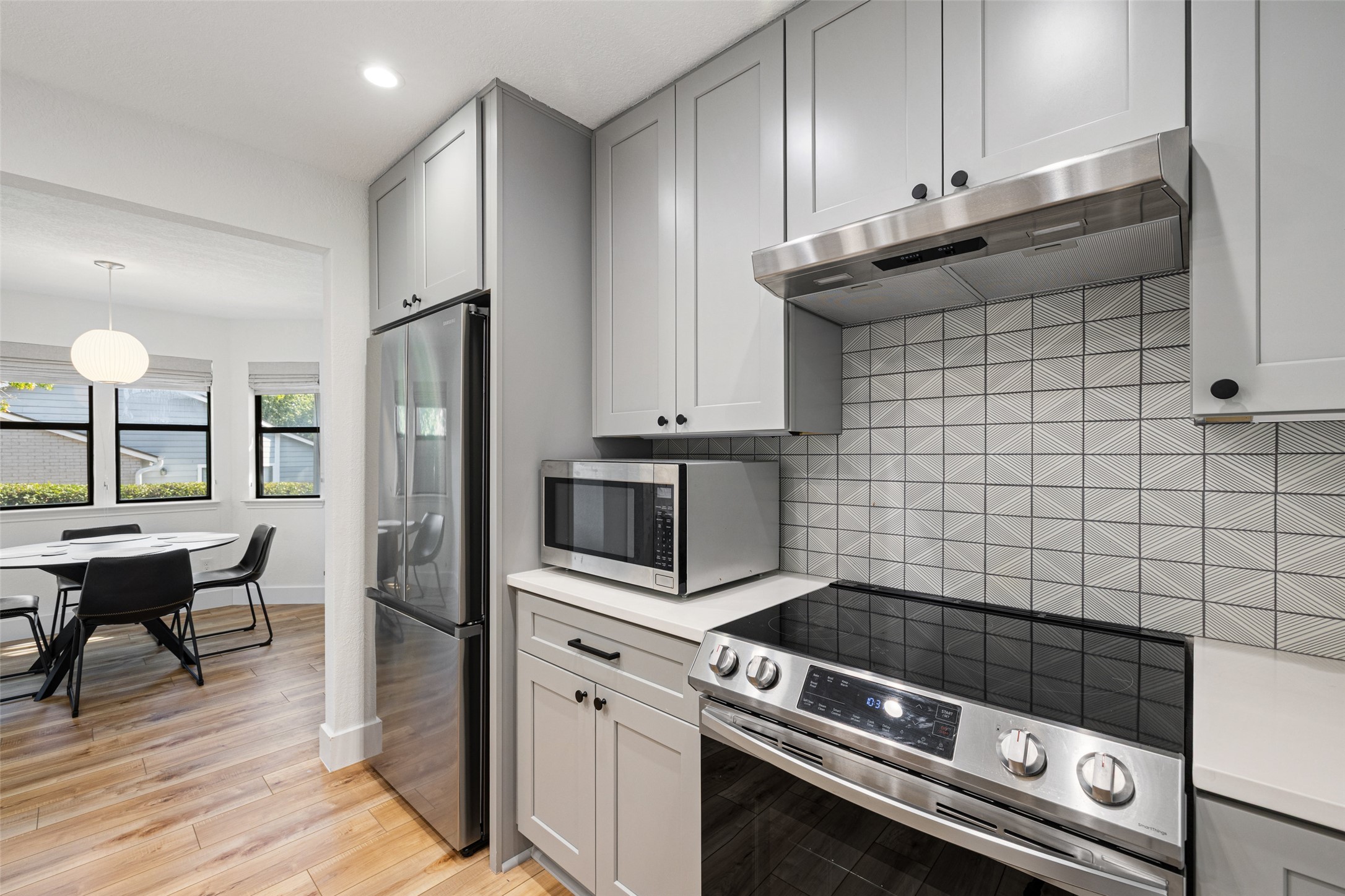2001 Parker Lane, Unit 101 Austin, TX 78741 - Photo 9 of 33 a kitchen with granite countertop a stove a refrigerator and wooden cabinets