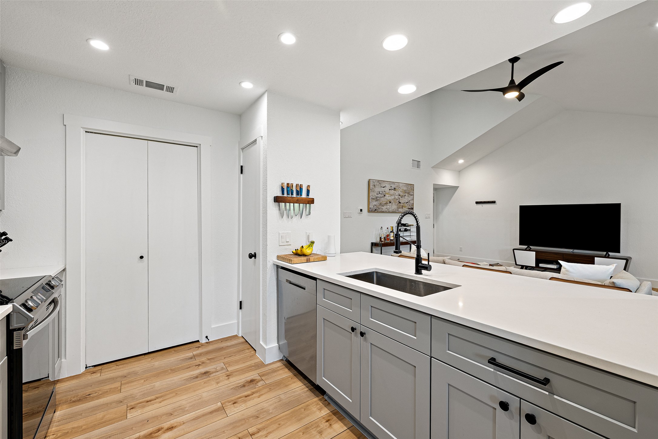 2001 Parker Lane, Unit 101 Austin, TX 78741 - Photo 10 of 33 a kitchen with a sink and a large mirror