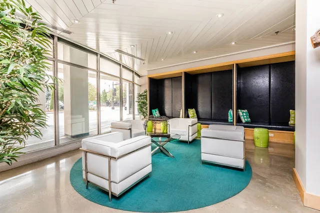 a living room with fireplace furniture and a large window