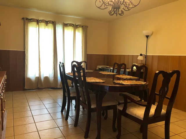 a view of a dining room with furniture and window