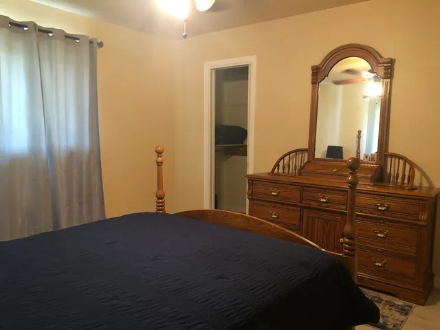 a bedroom with a bed and a dresser