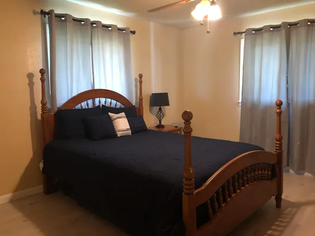 a bedroom with a bed and a mirror