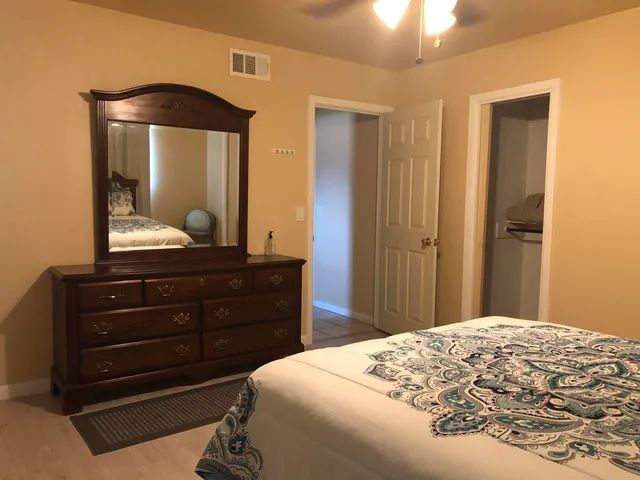 a bedroom with a bed and a mirror