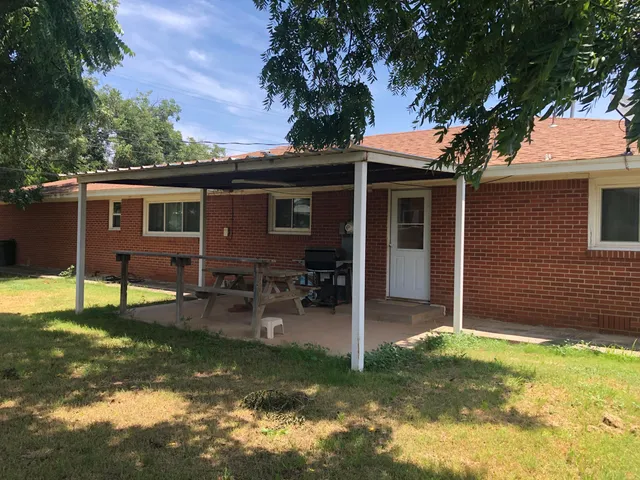 a view of house with backyard space and swimming pool