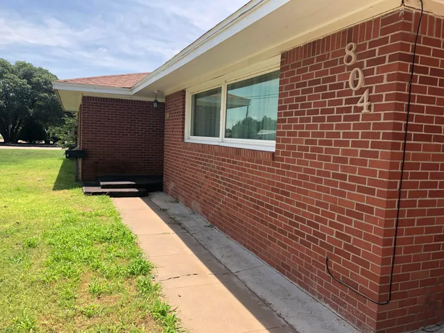 a view of front door of house with yard