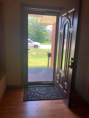 a view of front door with a mirror