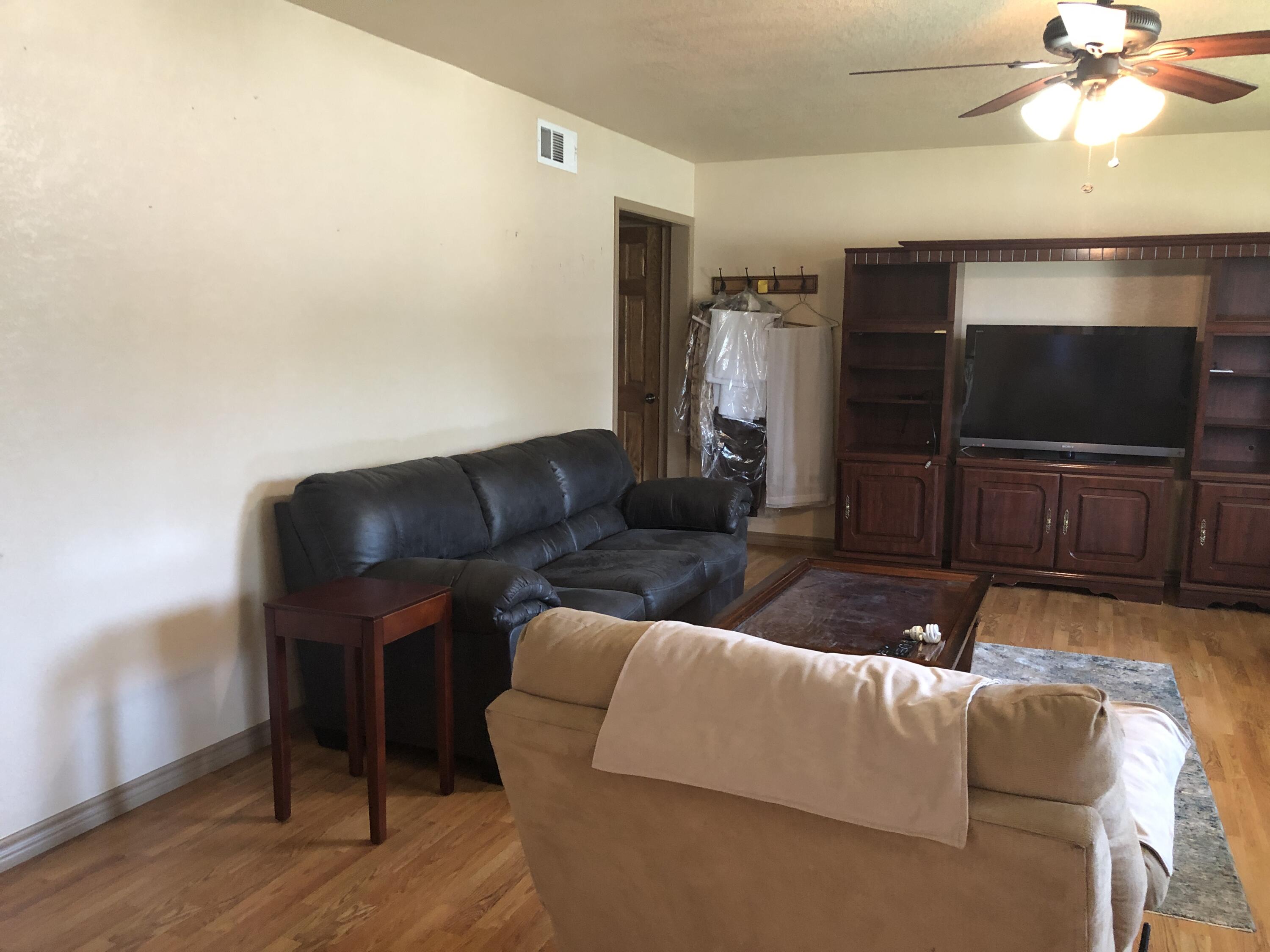 804 South Broadway Plainview, TX 79072 - Photo 7 of 46 a living room with furniture and a flat screen tv