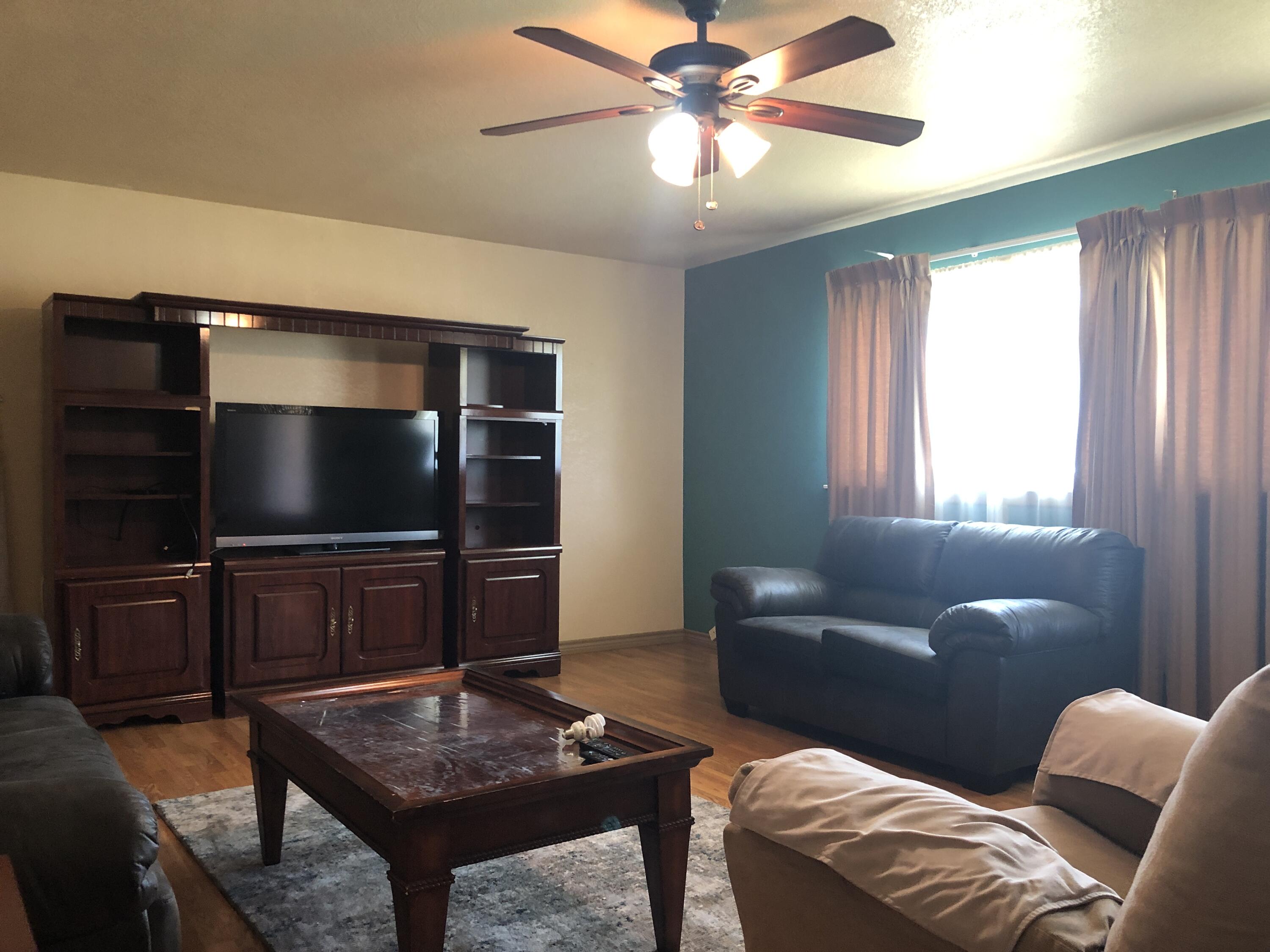 804 South Broadway Plainview, TX 79072 - Photo 8 of 46 a living room with furniture and a flat screen tv