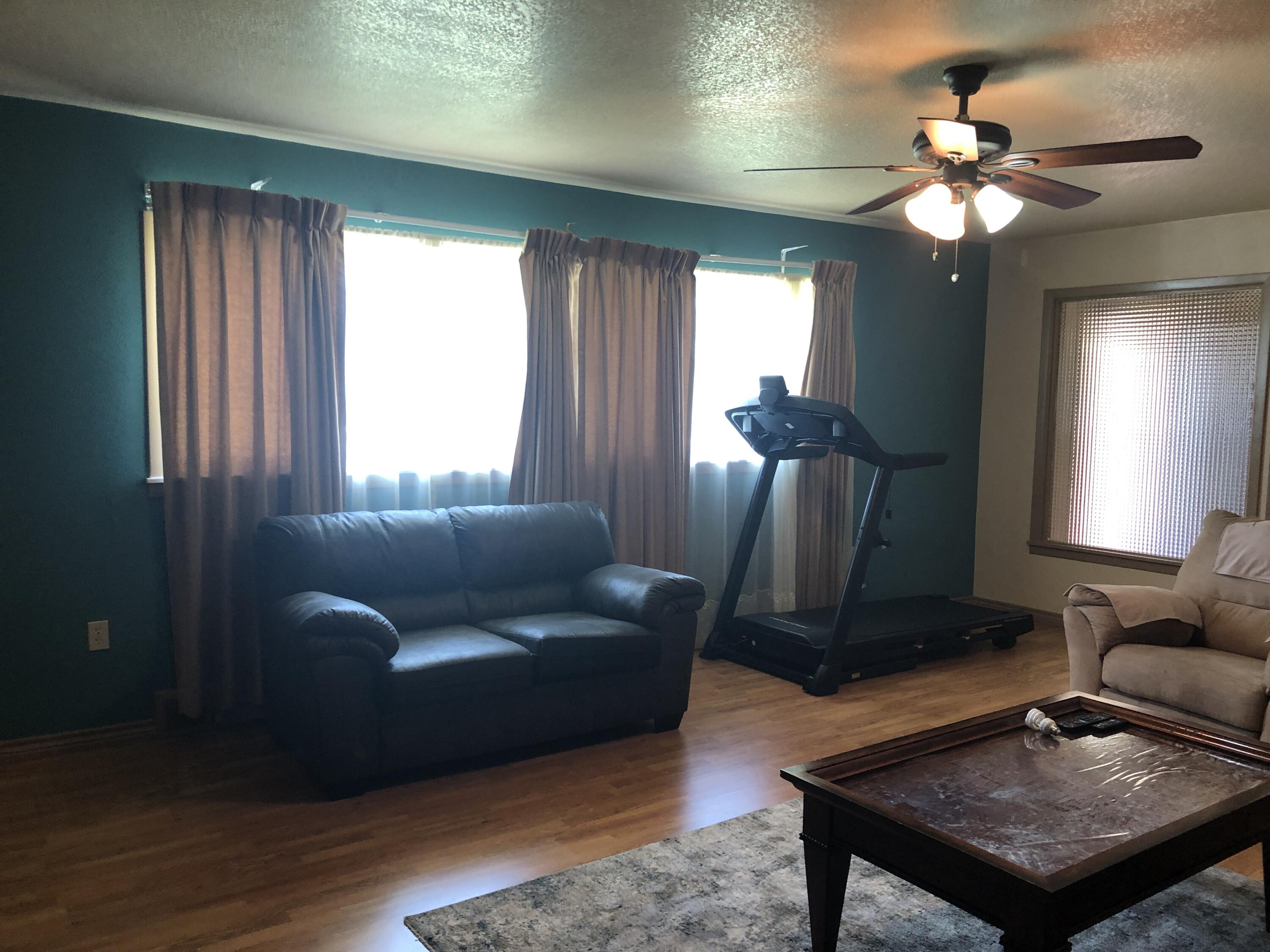 804 South Broadway Plainview, TX 79072 - Photo 9 of 46 a living room with furniture and a chandelier