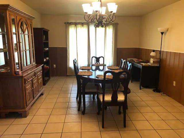 a dining room with furniture and window