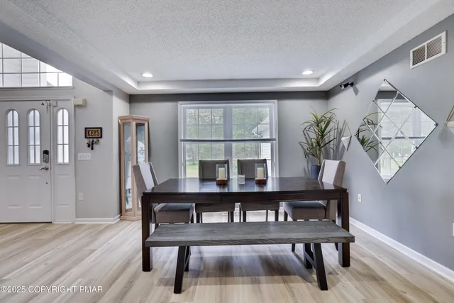 a living room with furniture and a clock