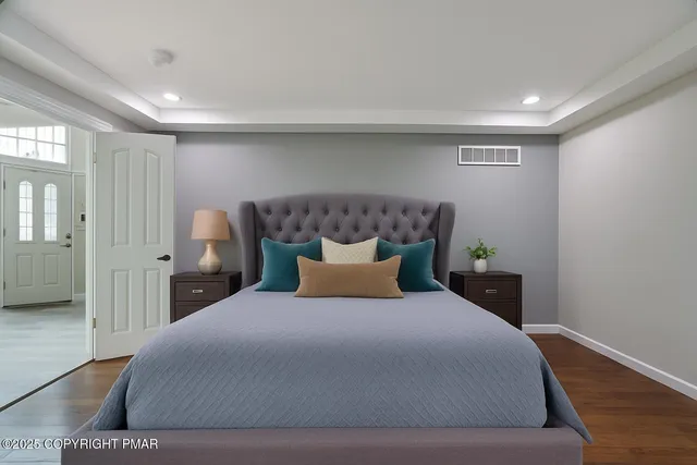 a bathroom with a double vanity sink a mirror and a bathtub