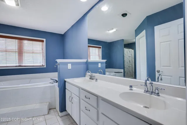 a bathroom with a bathtub and a sink