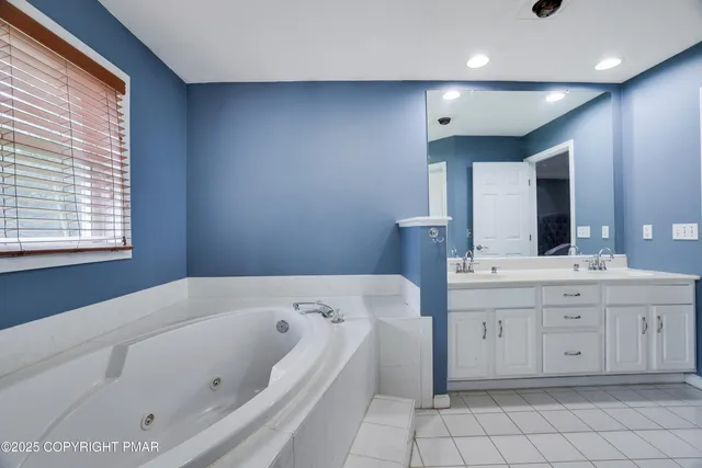 a bathroom with a bathtub and a window