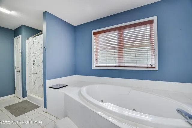 a view of walk in closet with clothes